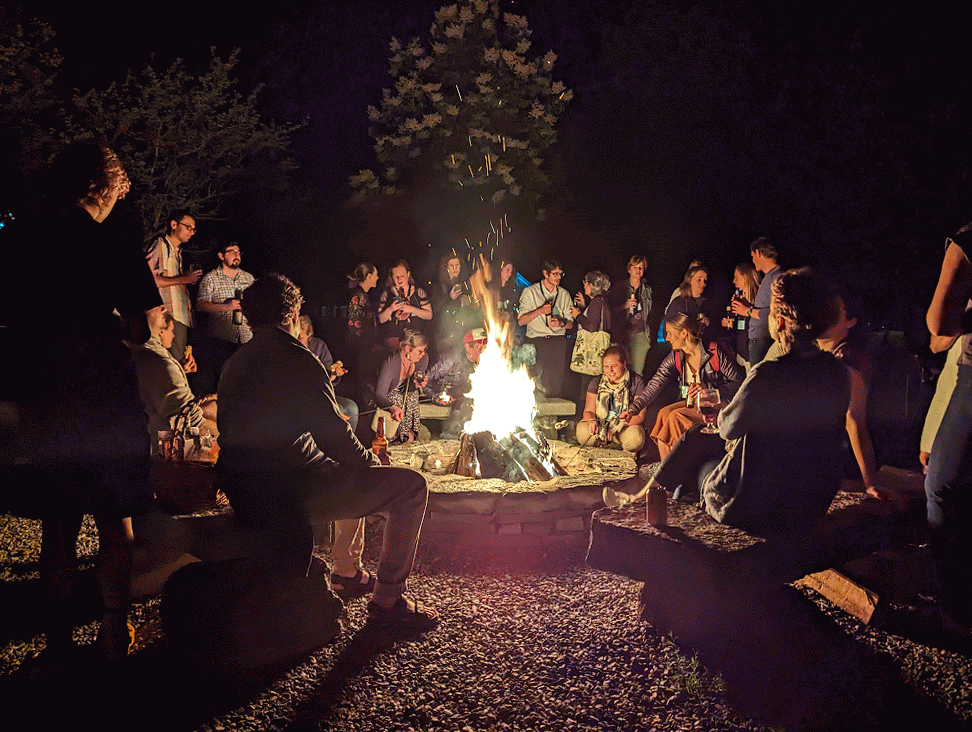 Scientists sit around bonfire at Gordon Research Conference on Catchment Science in Andover, NH.